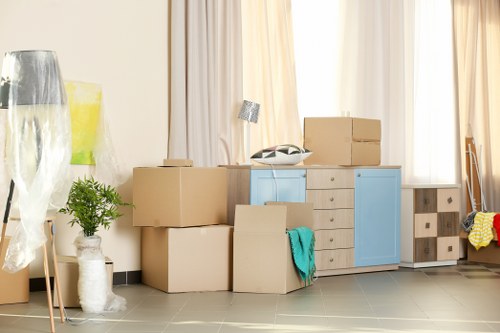 Furniture removals team handling a sofa move in a Tooting residential street
