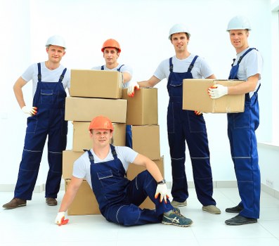 Local movers transporting a grand piano with specialist equipment