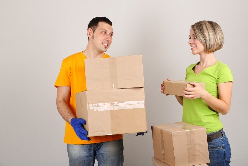 Professional movers navigating stairs and narrow access in a Tooting property