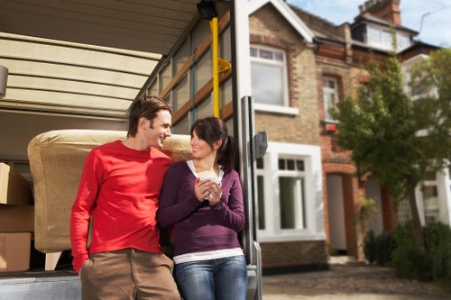 Trained movers handling furniture carefully in a residential property